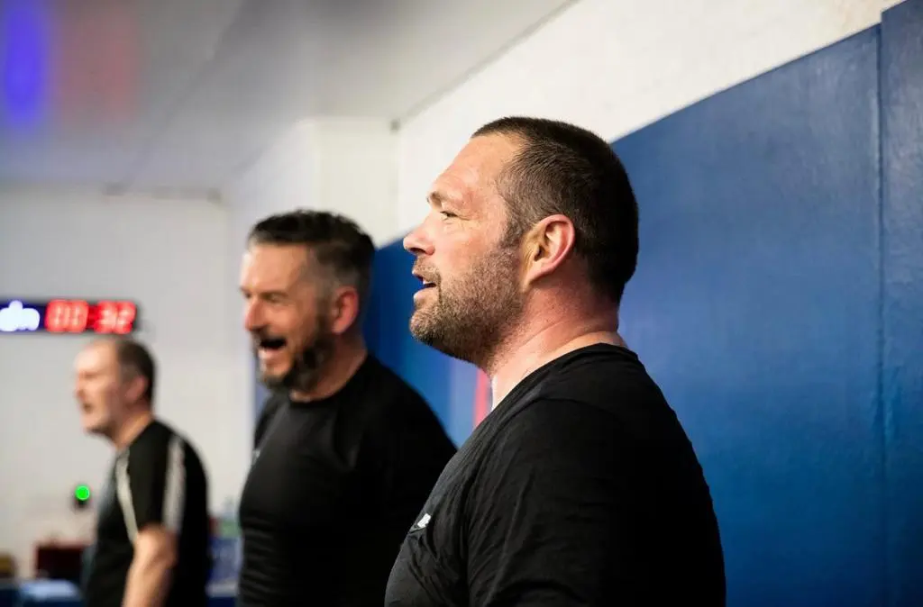 Coaches cheering from ringside