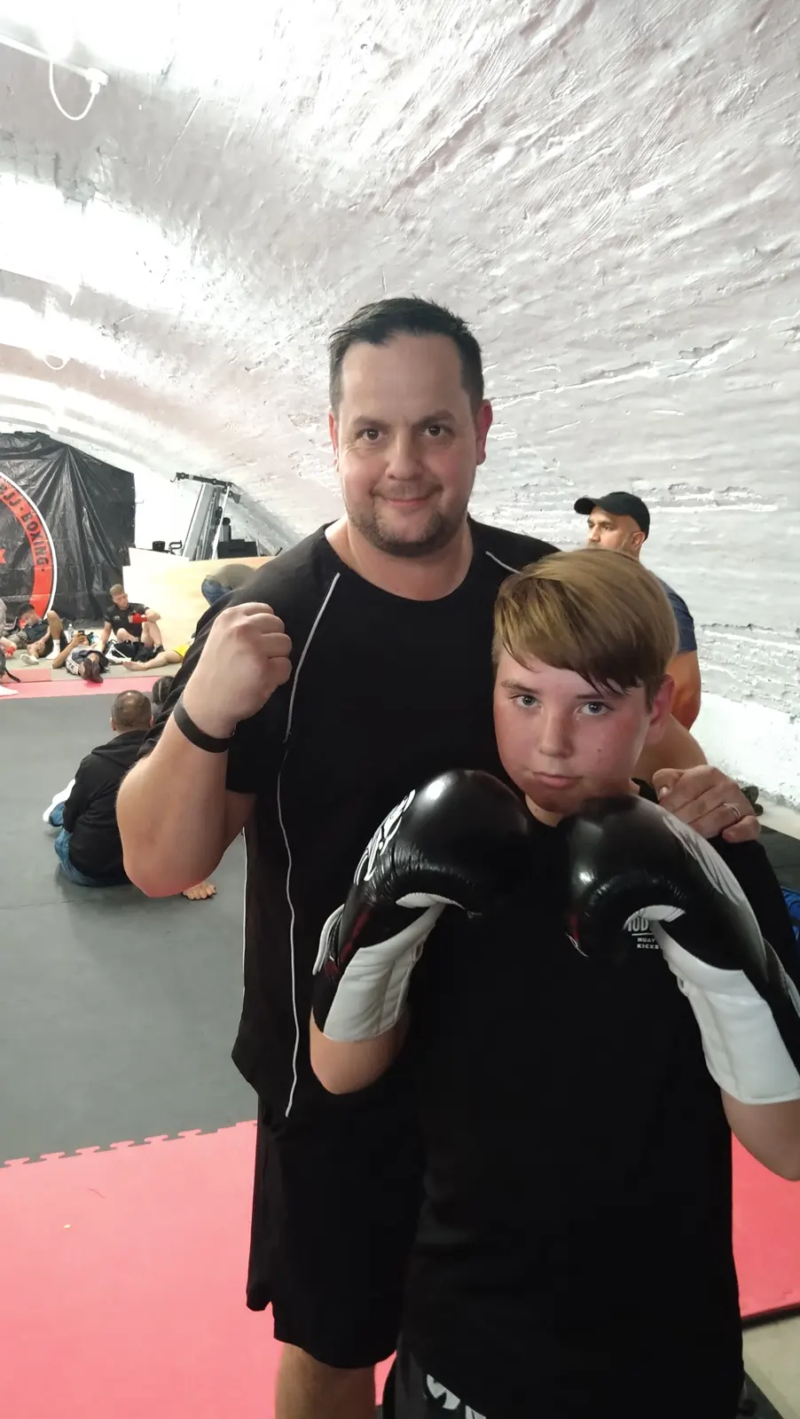 Coach with a young member in gloves