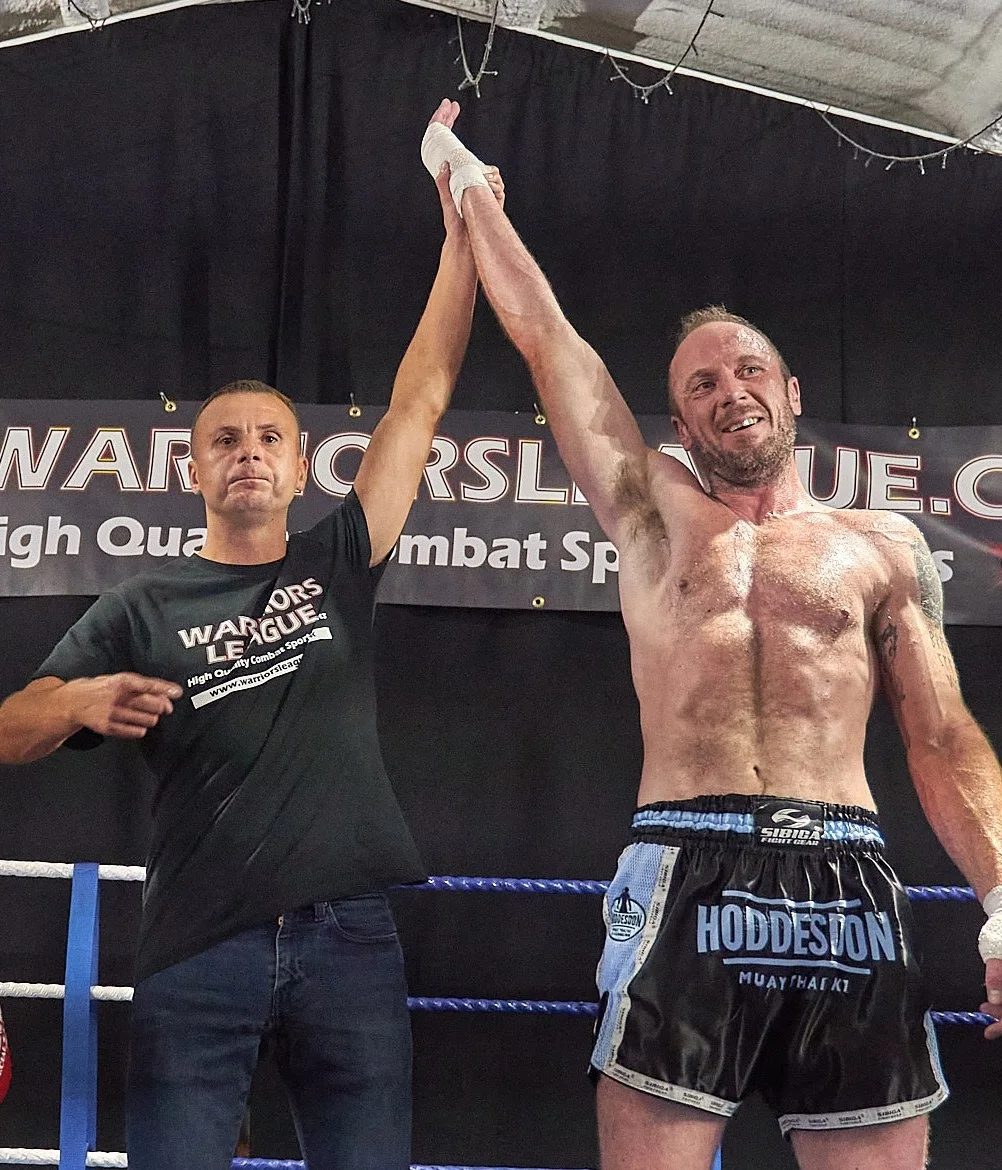 Steve Saunders has his hand raised at Warriors League