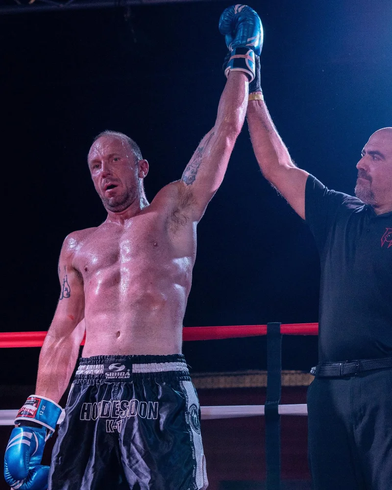 Steve Saunders with his hand raised after a win