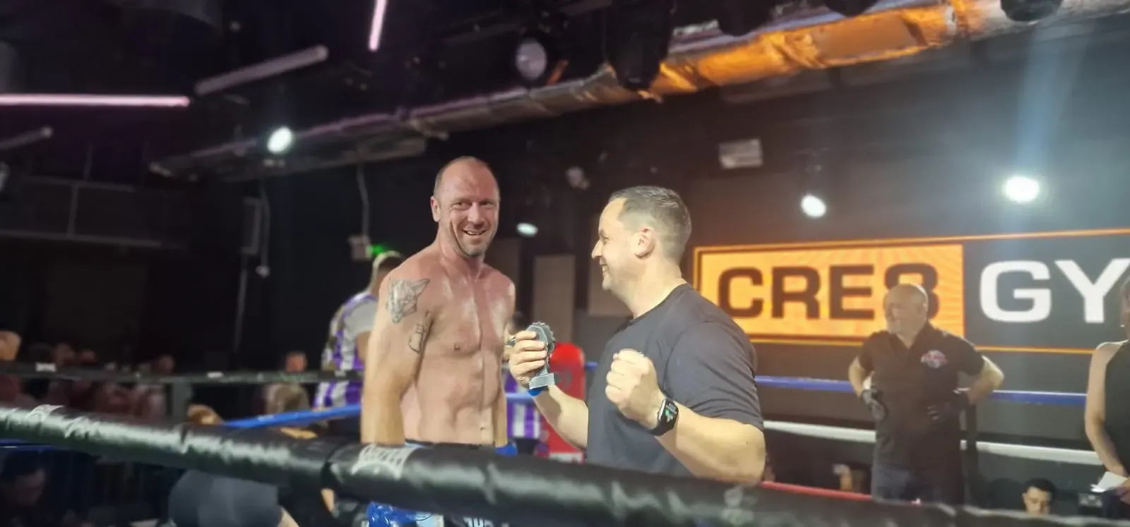 Fighter and coach celebrating a win